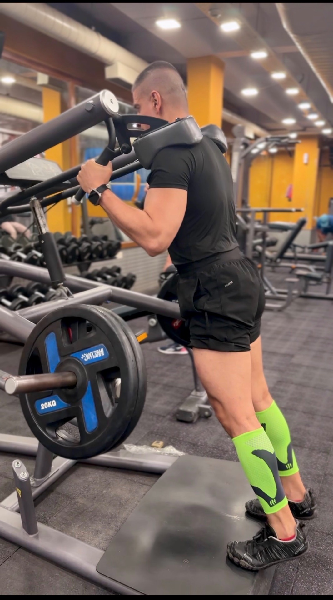 Man training calves on a leg press machine in the gym — personal photograph