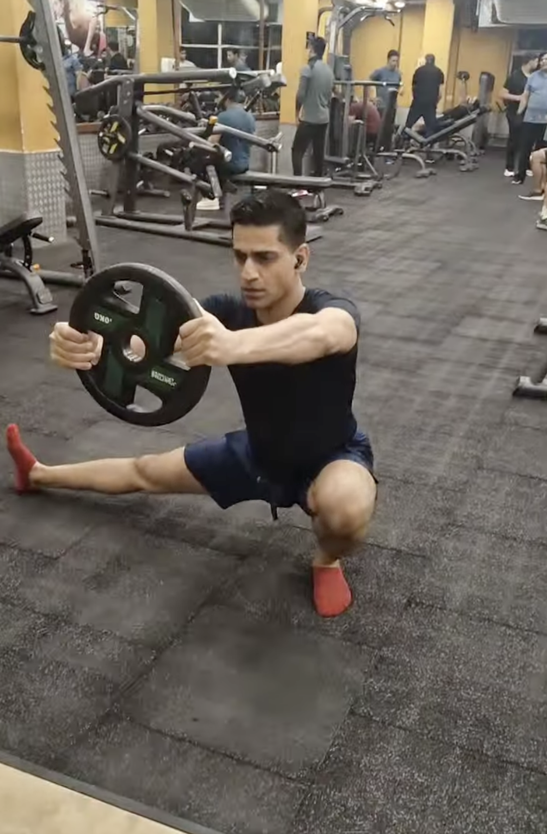 Shiva Malhotra ACE certified personal trainer performing a weighted Cossack squat in minimalist flat shoes, demonstrating natural foot strength and movement for adults over 35