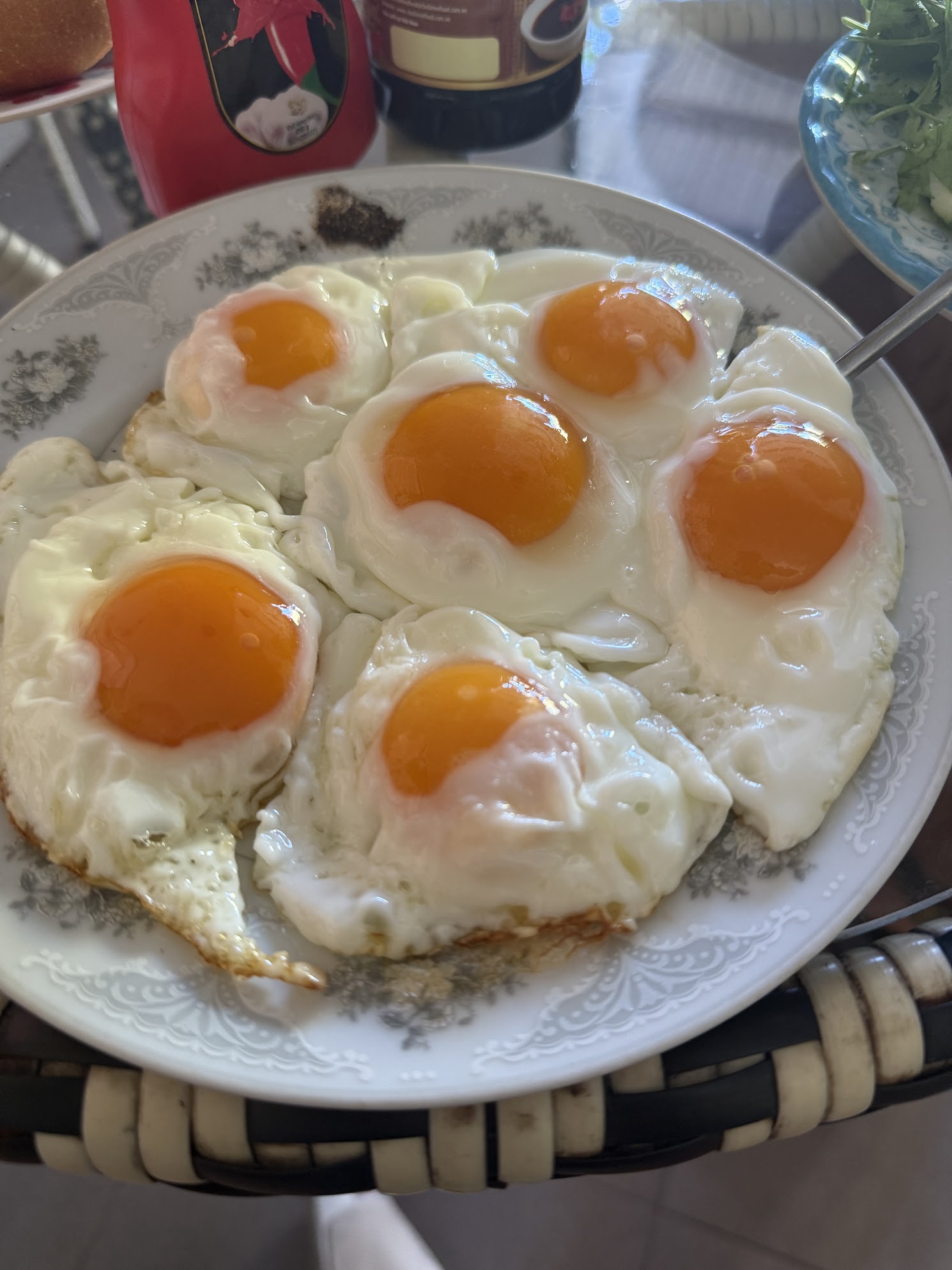 Five fried eggs with bright orange yolks on a plate — a real high protein breakfast demonstrating that egg yolks are safe and nutritious for adults over 35