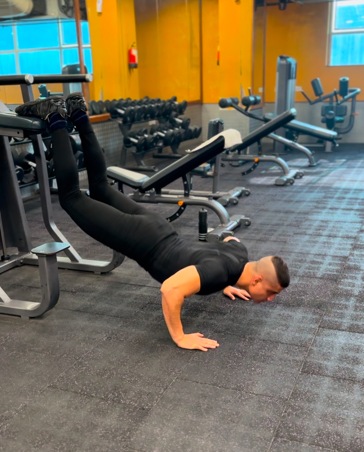 Shiva Malhotra ACE certified personal trainer performing an elevated push-up at the gym, demonstrating strength training for adults over 35